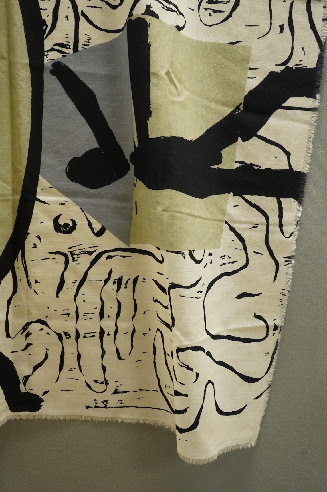 A large wool scarf designed with large faces by Brian Bolger, (RCA 1983) and The Cloth.100cm wide x 140cm. Condition - good